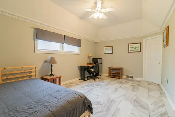 a bedroom with a bed and a chandelier