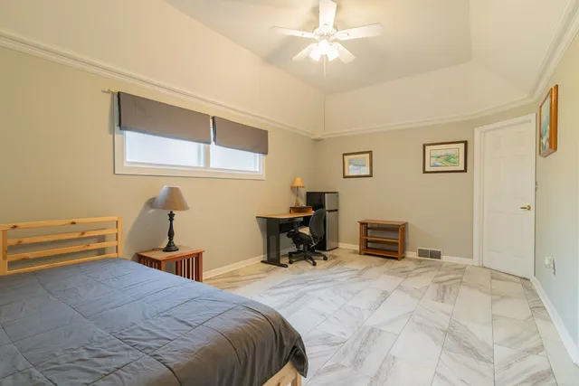 a bedroom with a bed and a chandelier