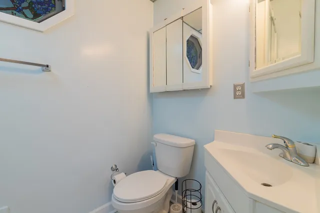 a white toilet sitting next to a bathroom sink