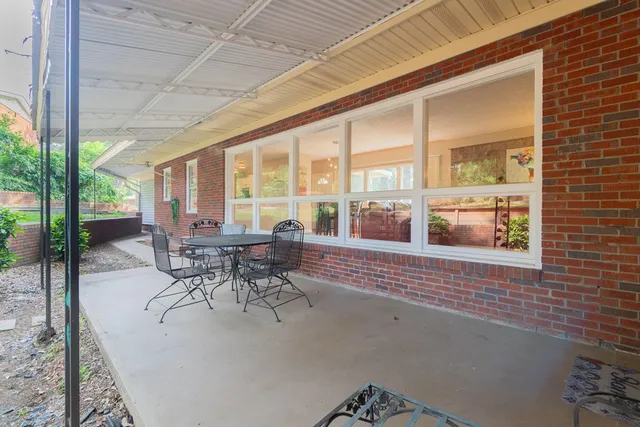 a view of a patio with table and chairs and potted plants