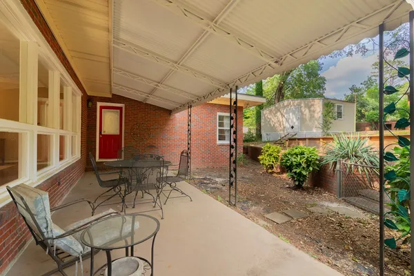 a building outdoor space with patio furniture and potted plants