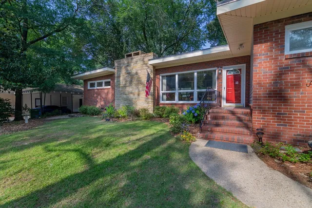 a front view of a house with garden