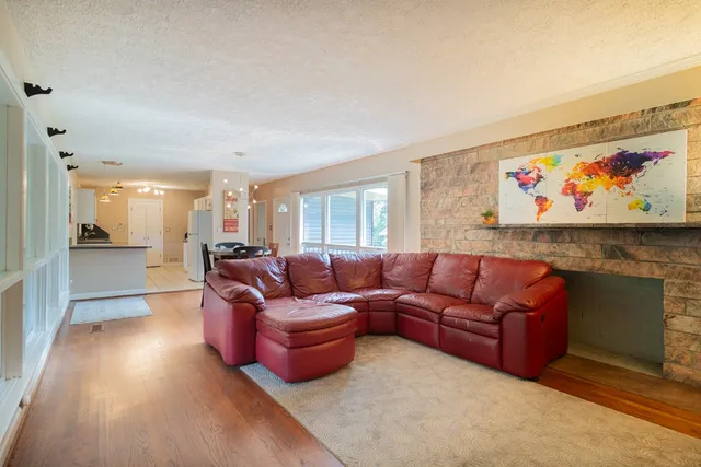 a living room with furniture and a kitchen view