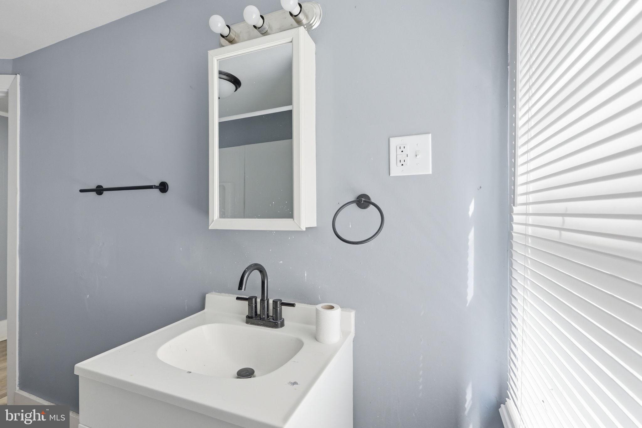 60 Walnut Street Salem, NJ 08079 - Photo 13 of 25 Sleek modern bathroom with soft hues.