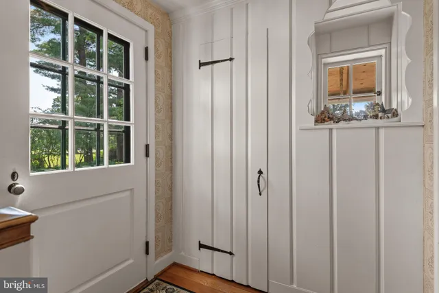 a view of a dining room with furniture a chandelier and wooden floor
