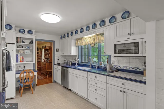 a spacious bedroom with a bed and dresser