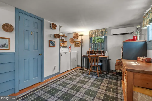 a spacious bedroom with a bed and a lamp on desk