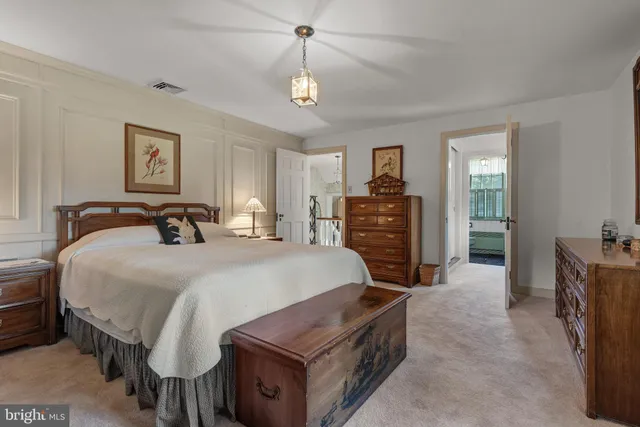 an aerial view of residential house with outdoor space and trees all around
