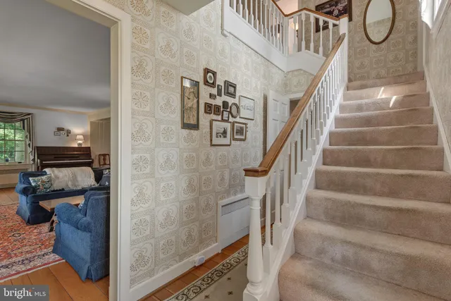 a kitchen with granite countertop white cabinets and window