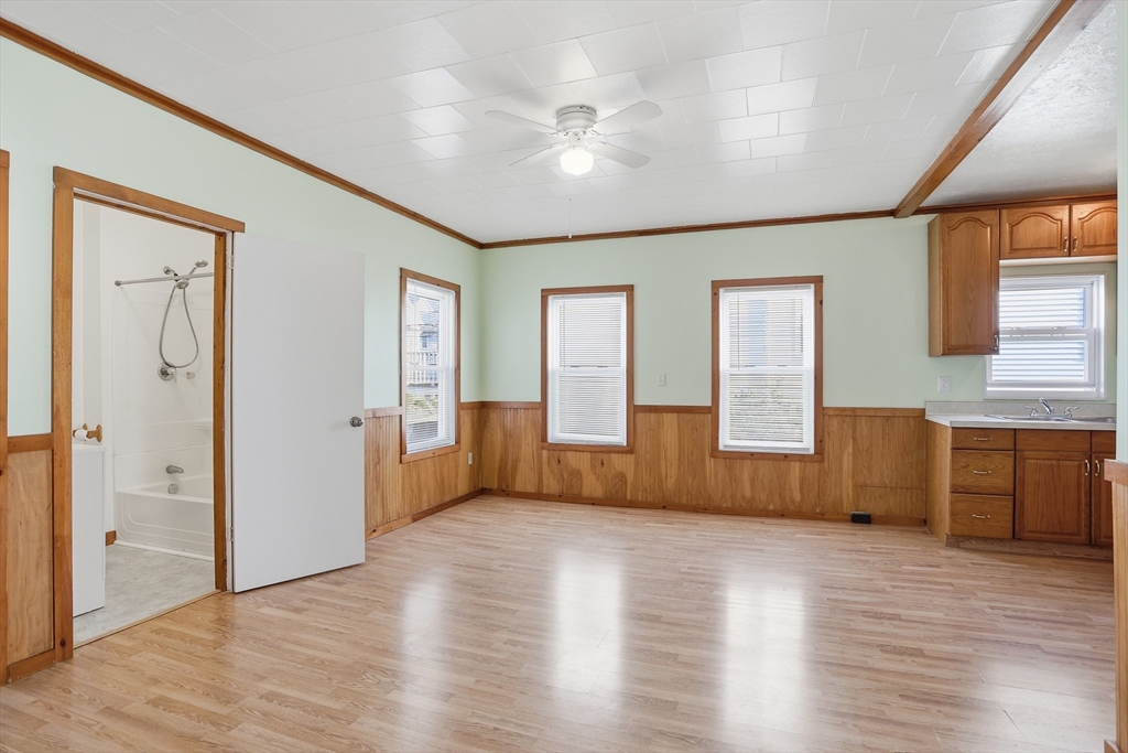 12 Whitcomb Street Webster, MA 01570 - Photo 12 of 40 a view of an empty room with a window and wooden floor