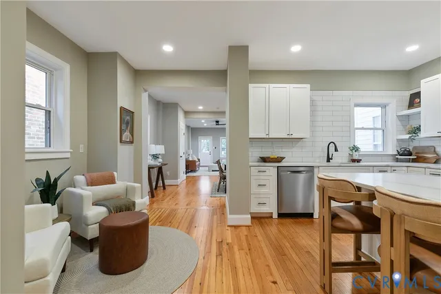 a living room with furniture wooden floor and a fireplace