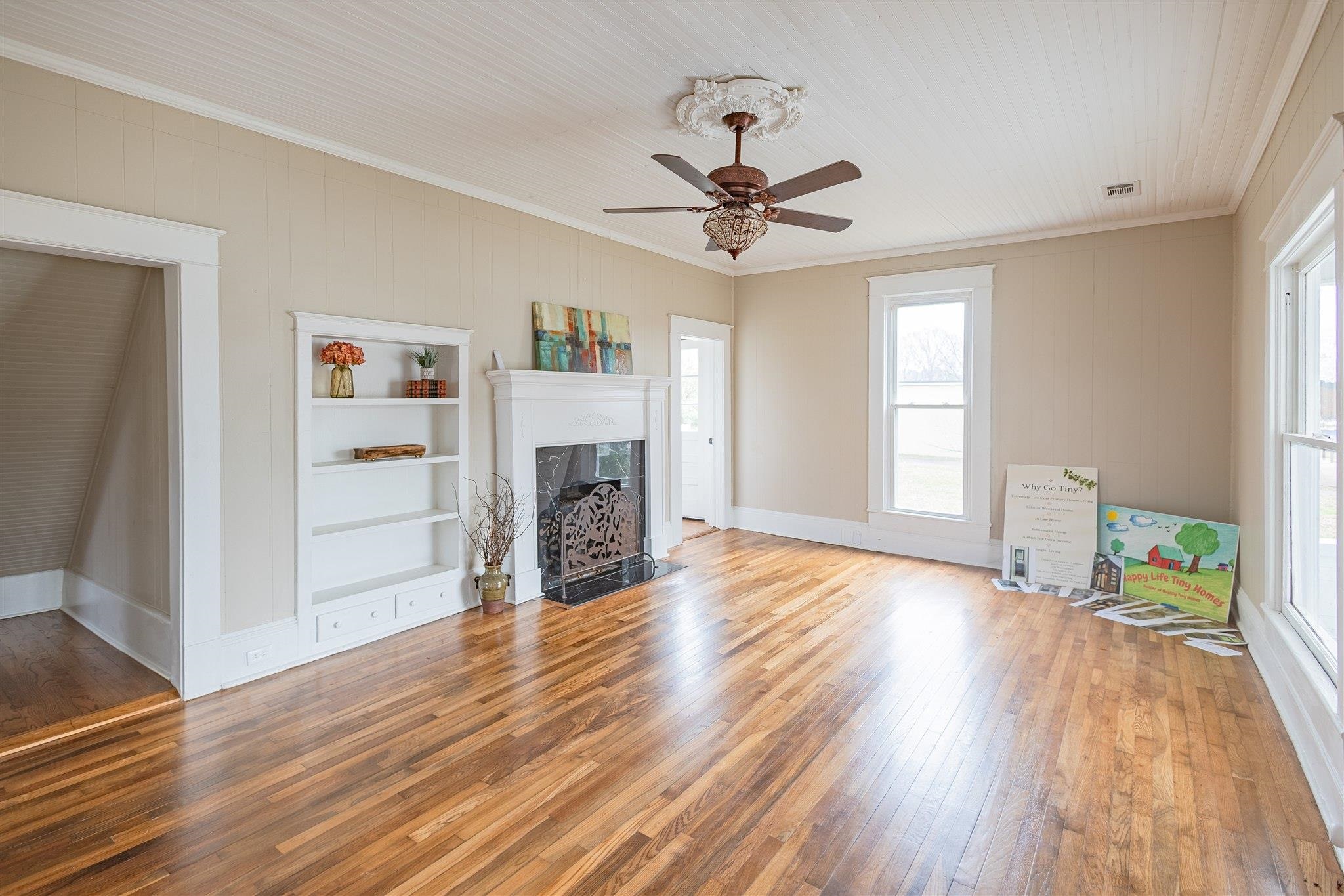 129 Warren Avenue Selmer, TN 38375 - Photo 14 of 28 a view of a livingroom with wooden floor a ceiling fan and a window