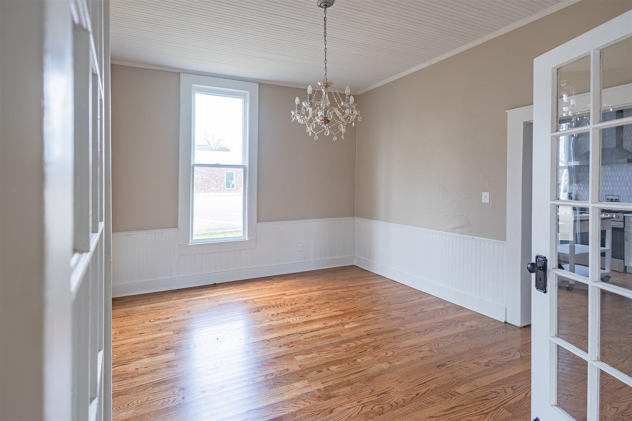 129 Warren Avenue Selmer, TN 38375 - Photo 16 of 28 a view of empty room with wooden floor and fan