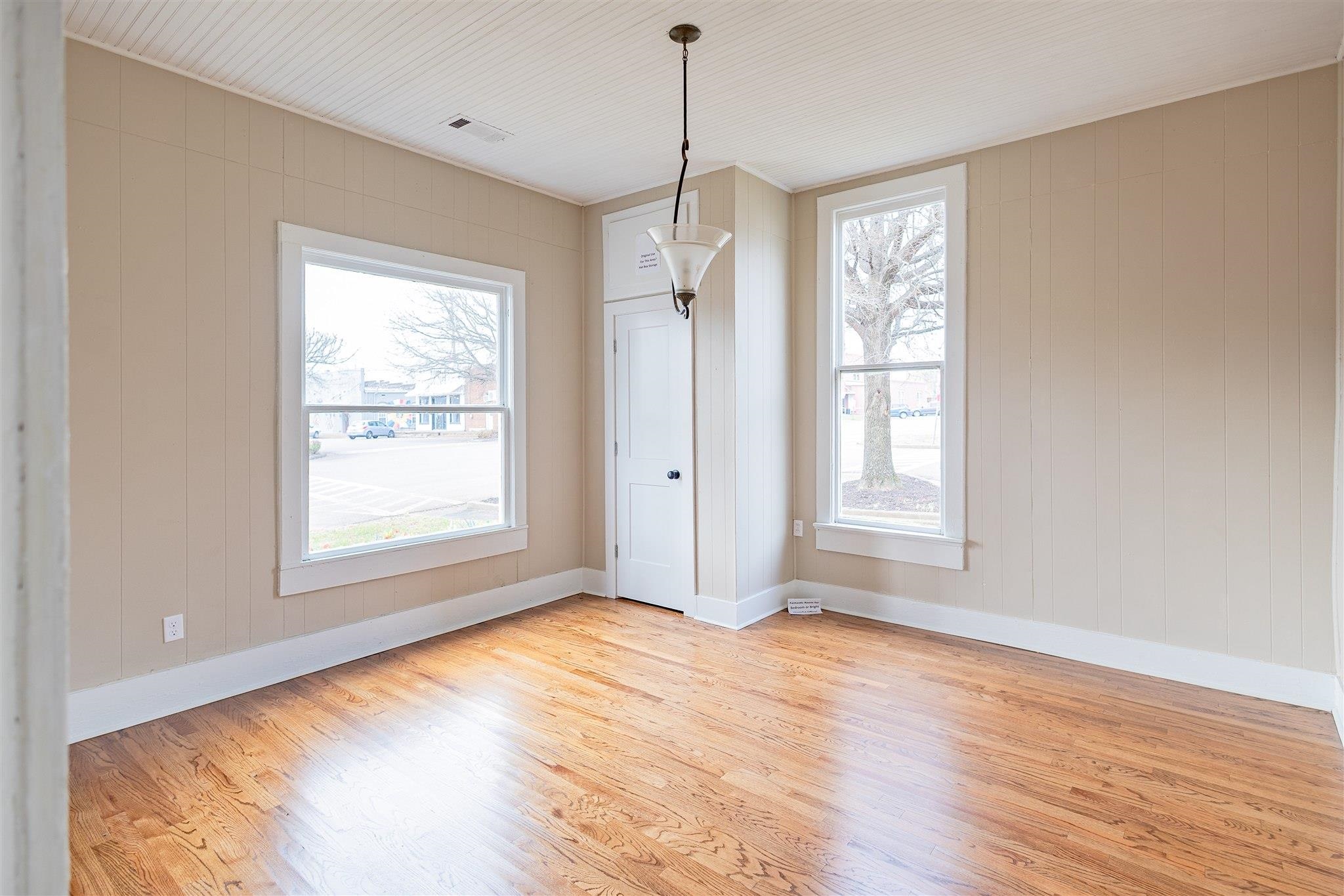 129 Warren Avenue Selmer, TN 38375 - Photo 17 of 28 a view of an empty room with a window and wooden floor