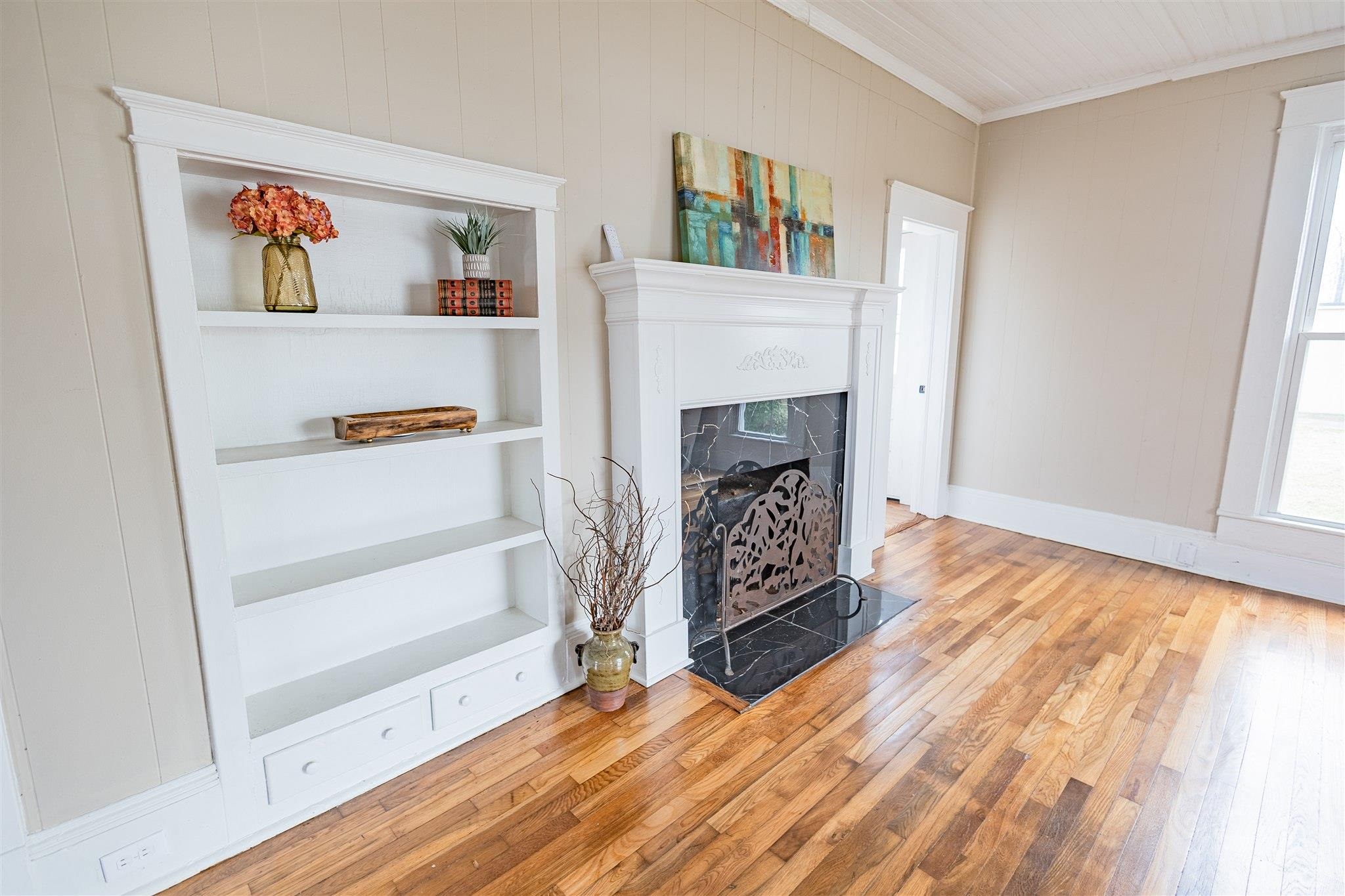 129 Warren Avenue Selmer, TN 38375 - Photo 18 of 28 a view of a livingroom with wooden floor and a fireplace