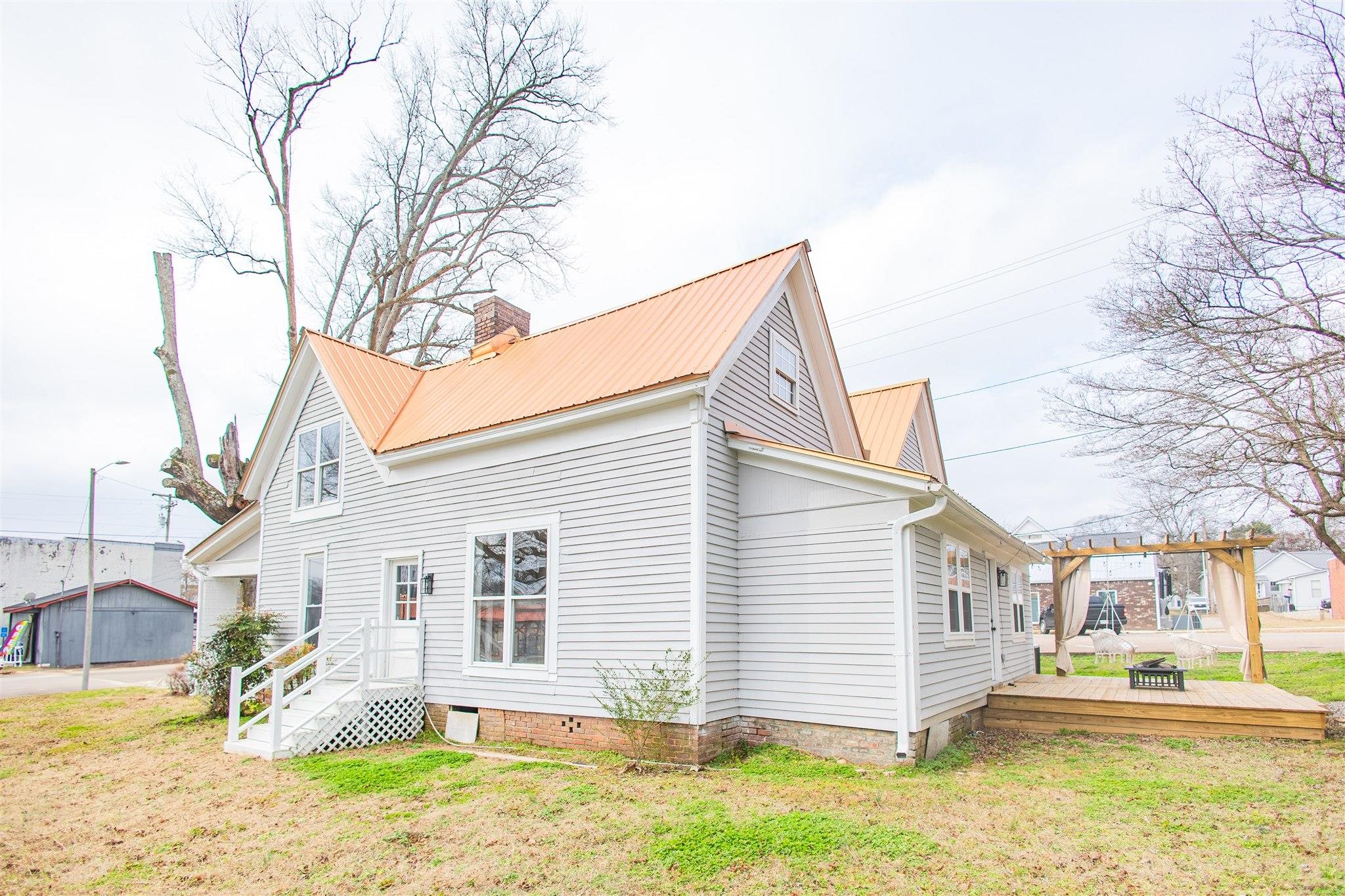129 Warren Avenue Selmer, TN 38375 - Photo 6 of 28 a view of a house with a yard and large tree