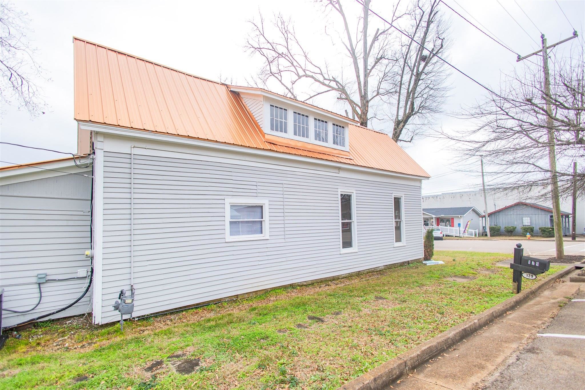 129 Warren Avenue Selmer, TN 38375 - Photo 8 of 28 a view of a house with a backyard
