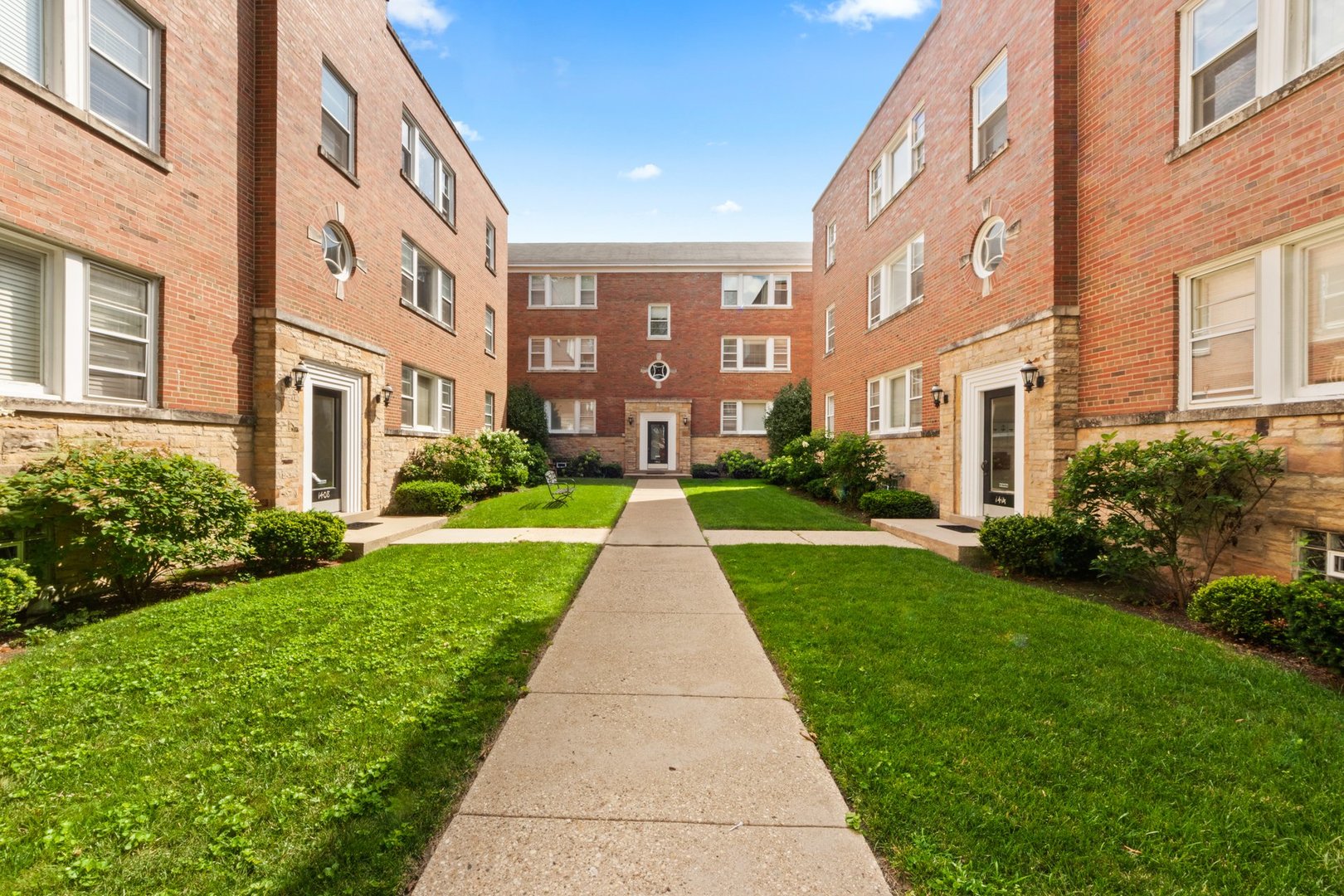 1408 Central Street, Unit 3N Evanston, IL 60201 - Photo 1 of 17 a view of a brick building next to a yard
