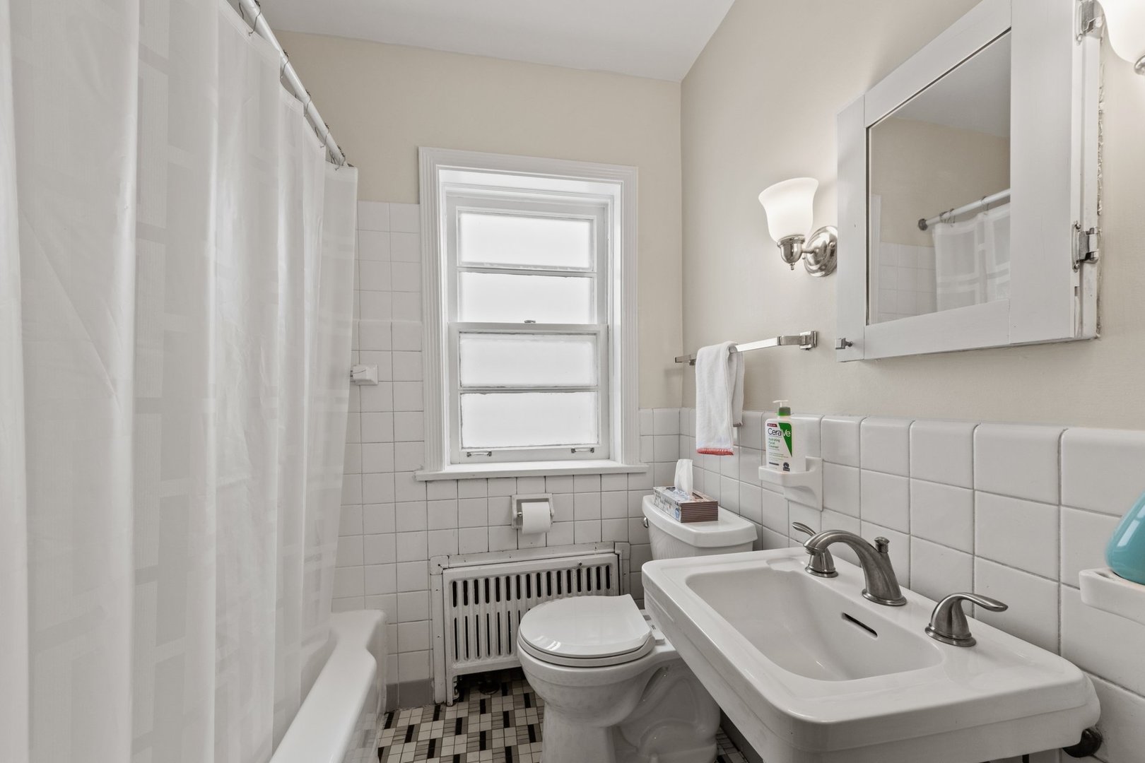 1408 Central Street, Unit 3N Evanston, IL 60201 - Photo 12 of 17 a bathroom with a sink toilet and a mirror