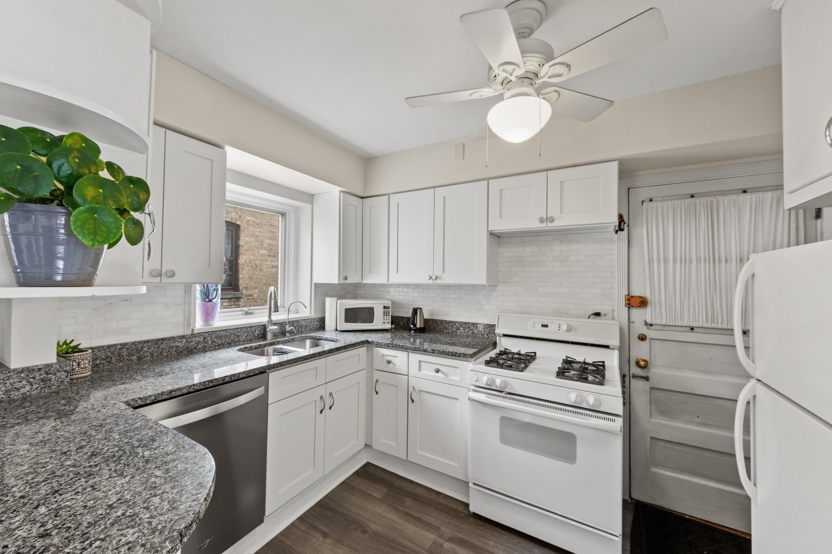 1408 Central Street, Unit 3N Evanston, IL 60201 - Photo 7 of 17 a kitchen with a white cabinets and white appliances