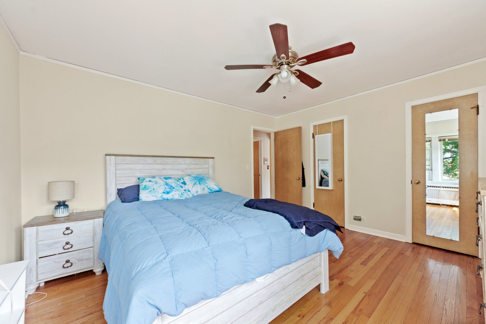 1408 Central Street, Unit 3N Evanston, IL 60201 - Photo 10 of 17 a bedroom with a large bed and wooden floor