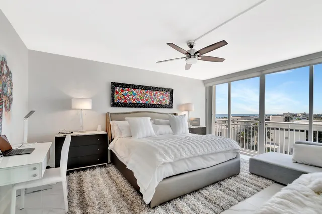 a bedroom with a large bed and a large window
