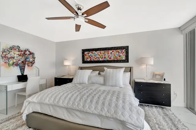 a bedroom with a large bed and a chandelier