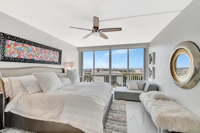 a bedroom with a bed and a large mirror