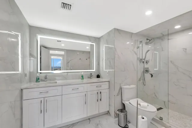 a spacious bedroom with a large bed and a large window