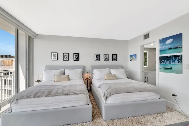 a bathroom with a double vanity sink toilet mirror and shower