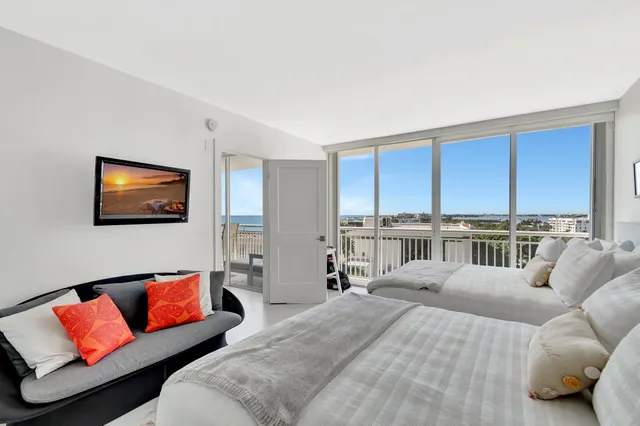 a bedroom with a large bed and a couch