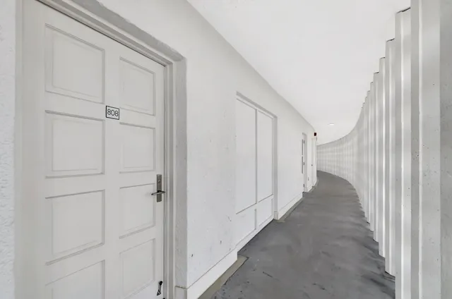 a view of a hallway with white walls