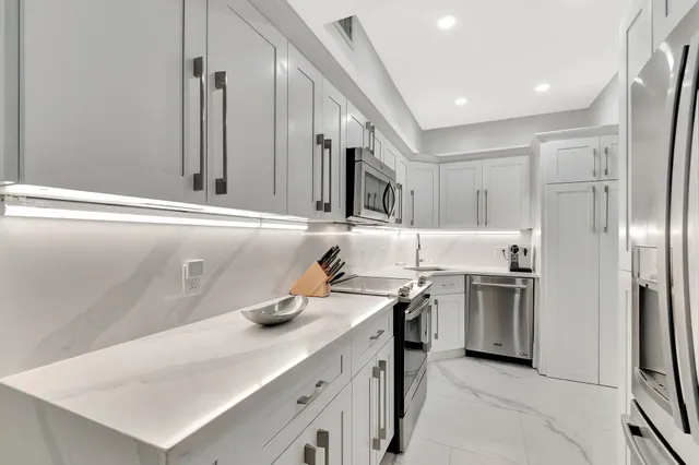 a kitchen with a sink stove and refrigerator