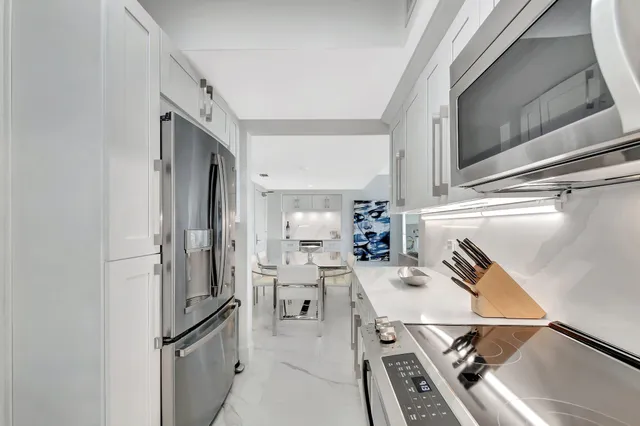 a kitchen with a sink appliances and cabinets