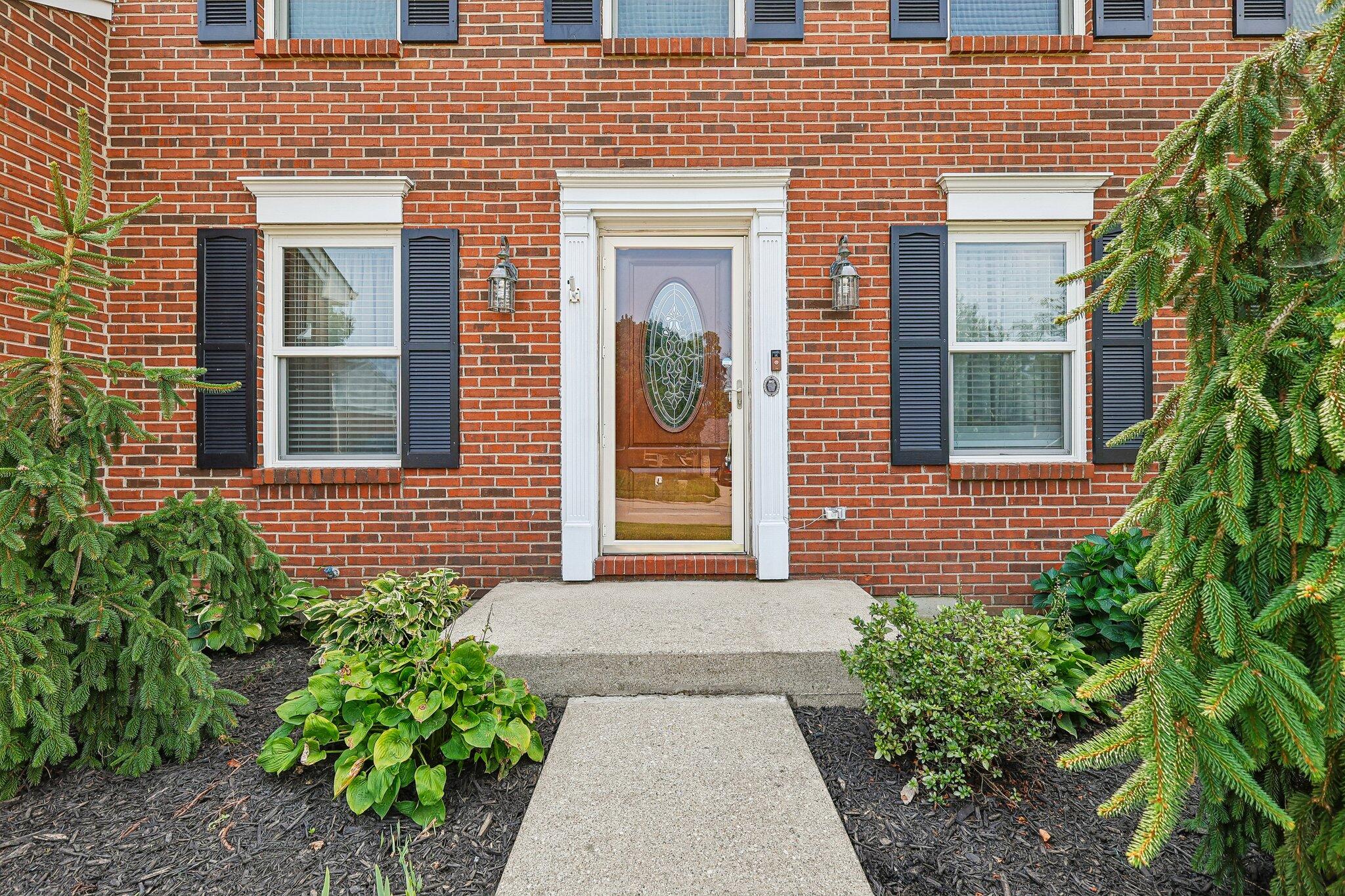 1317 Cayton Road Florence, KY 41042 - Photo 10 of 36 Brick facade with decorative shutters and a central entry door featuring an oval glass insert