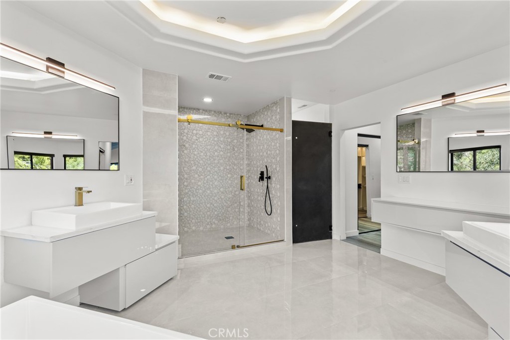 106 Buckskin Road Bell Canyon, CA 91307 - Photo 19 of 54 a bathroom with a double vanity sink mirror and shower