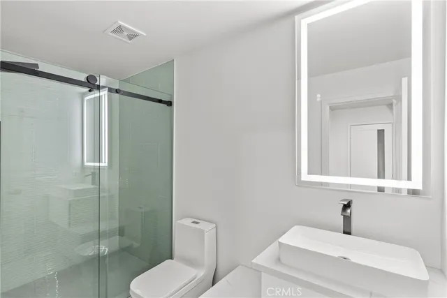 a bathroom with a shower and a sink