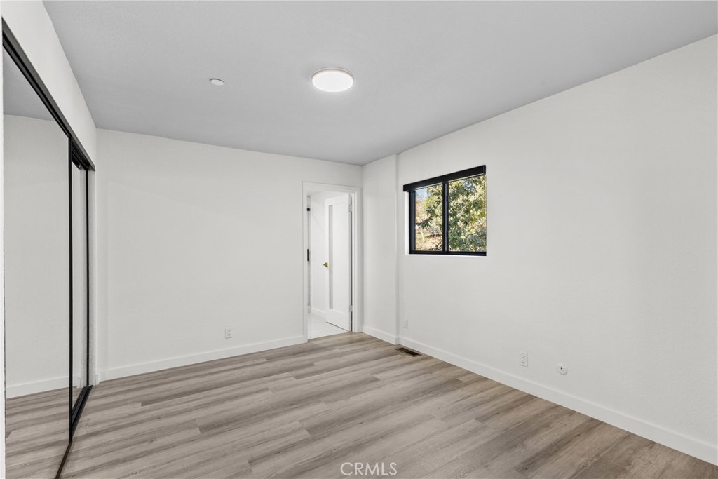 106 Buckskin Road Bell Canyon, CA 91307 - Photo 30 of 54 an empty room with wooden floor and window