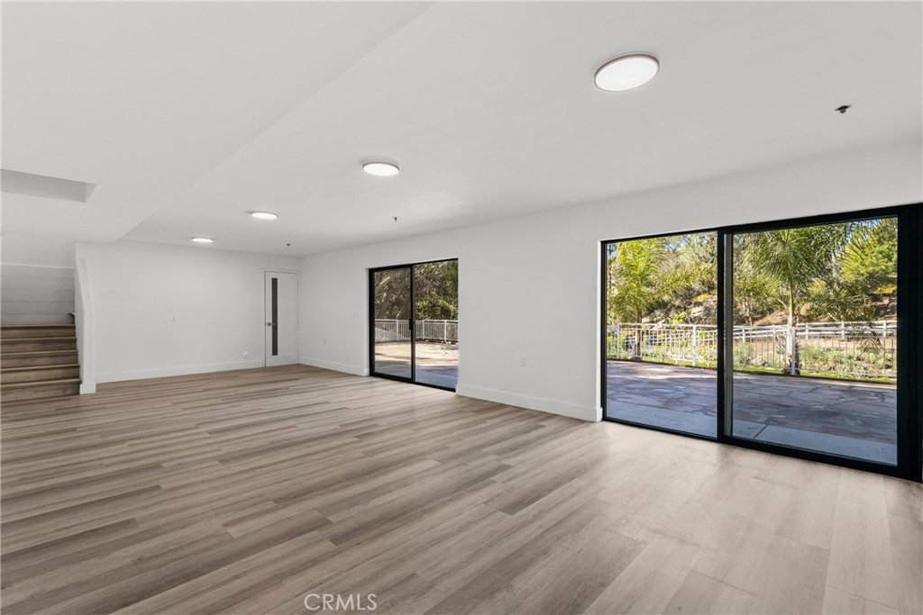 106 Buckskin Road Bell Canyon, CA 91307 - Photo 33 of 54 an empty room with wooden floor and windows