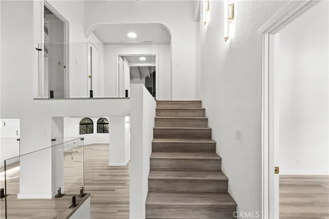 a view of entryway and hall with wooden floor