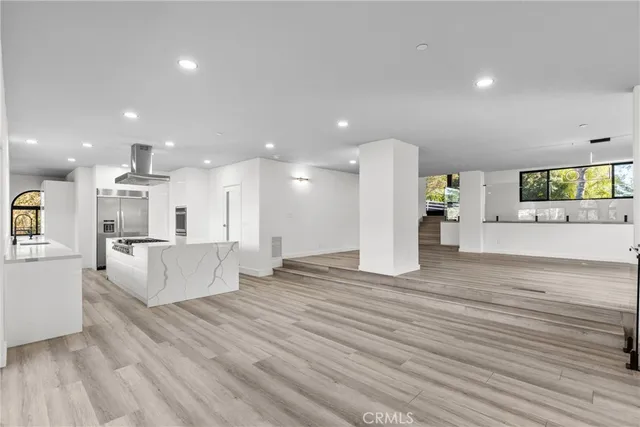 a kitchen with stainless steel appliances granite countertop a stove a sink and a refrigerator