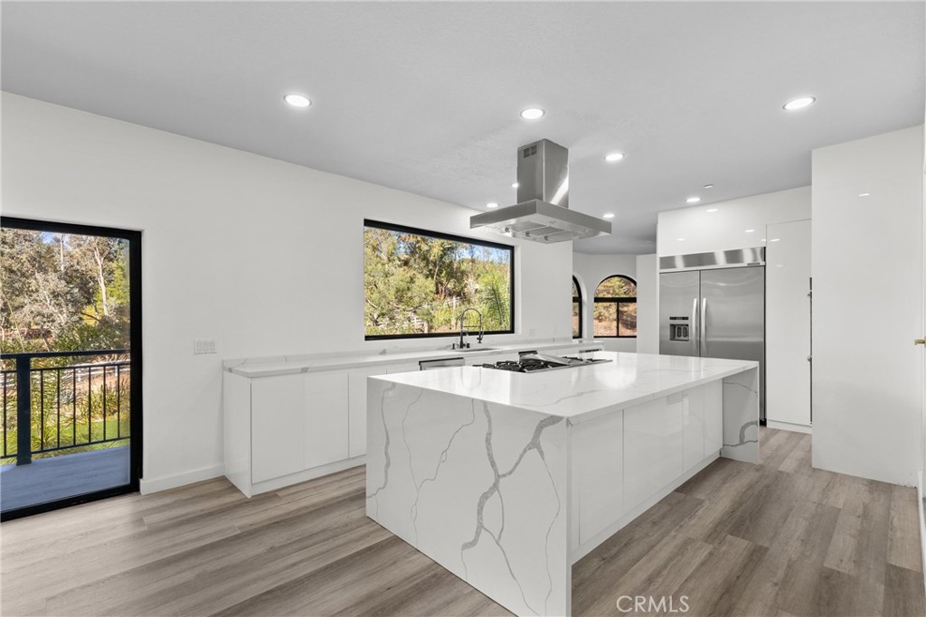 106 Buckskin Road Bell Canyon, CA 91307 - Photo 7 of 54 a large kitchen with stainless steel appliances a sink and a large window