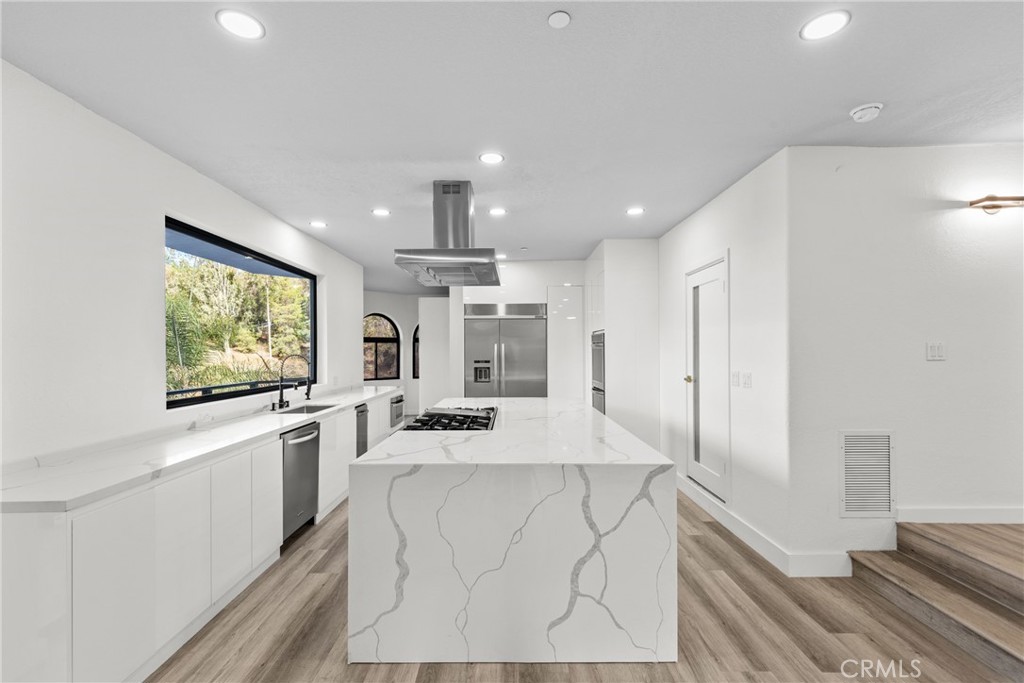 106 Buckskin Road Bell Canyon, CA 91307 - Photo 8 of 54 a large kitchen with kitchen island a large counter top space a sink stainless steel appliances and cabinets