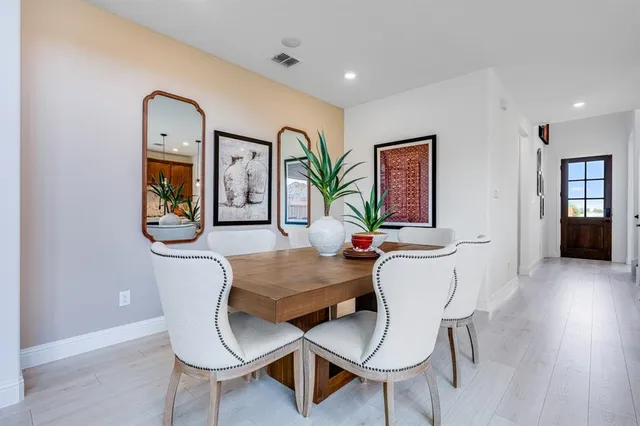 a kitchen with stainless steel appliances granite countertop a stove a sink dishwasher and a refrigerator with wooden floor