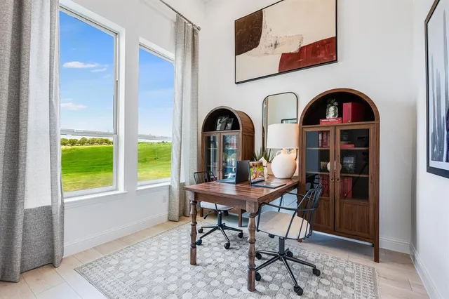 a living room with furniture a rug and a large window