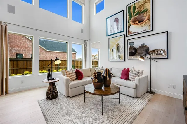 a living room with furniture large window and a table