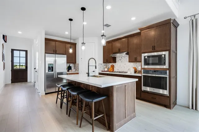 a bathroom with a double vanity sink mirror and shower