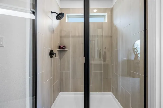 a bathroom with a sink a toilet and a shower