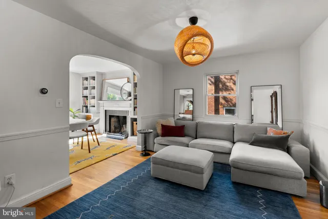 a living room with furniture a fireplace and a table