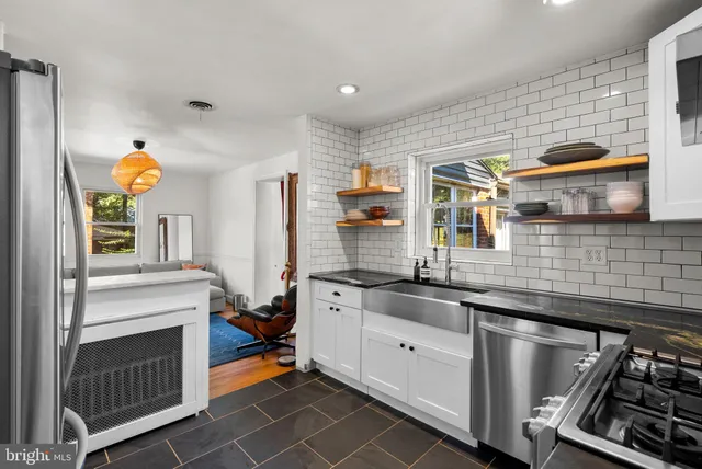 a kitchen with stainless steel appliances granite countertop a stove and a sink